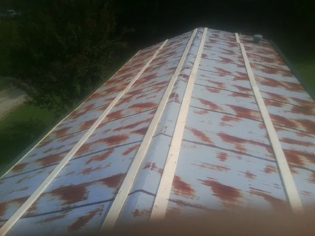 Rusted metal roof panels with new wood purlins before replacement — Storm Damage Roof Repair in Gauley Bridge by Roofing Brothers